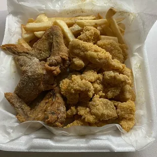a basket of fried fish and fries