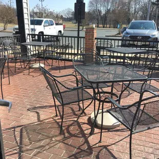 a patio with tables and chairs