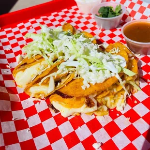 tacos on a red and white checkered tray