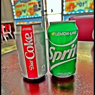 two soda cans on a table