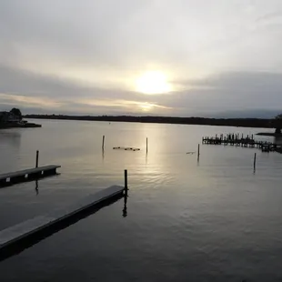 the sun setting over the water