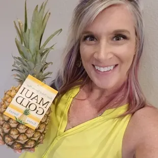 a woman holding a pineapple