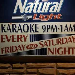 a sign advertising a karaoke night