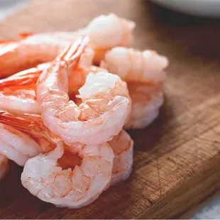 a pile of shrimp on a cutting board
