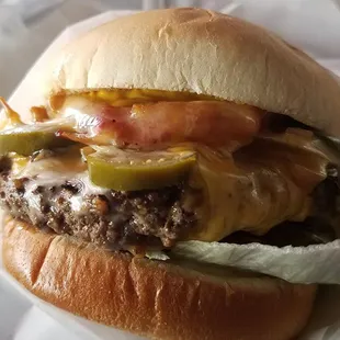 Junkyard Burger.  1/2 pound patty, bacon, mushrooms, bell pepper, jalapenos, three cheeses, lettuce, pickles, tomato, and onion.