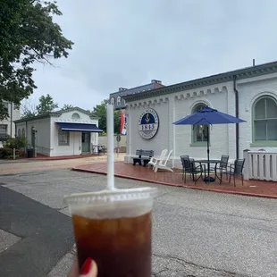 a hand holding a cup of coffee