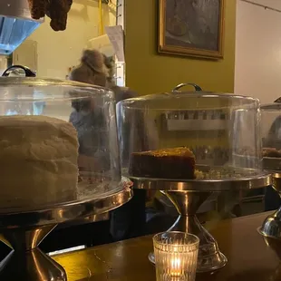 a row of cakes on display in a bakery