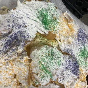a king cake with frosting and sprinkles