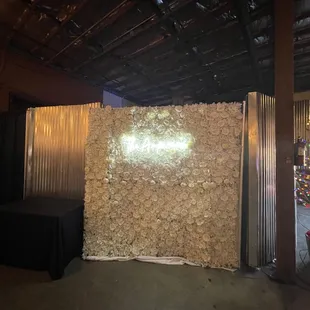 Floral wall with neon sign