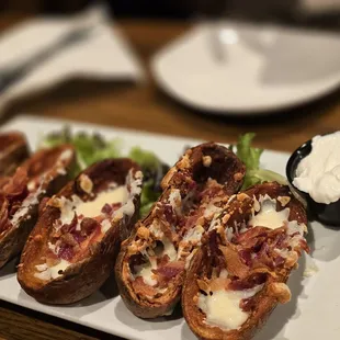 Loaded potato skins with sour cream.