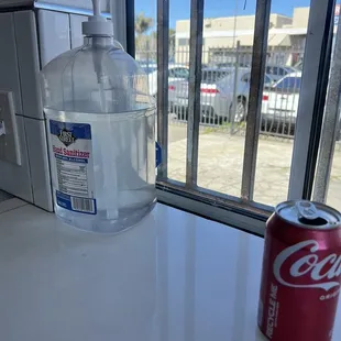 a can of soda next to a window