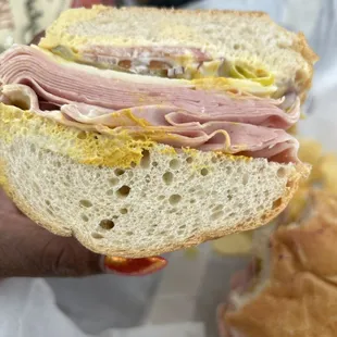 Mortadella sandwich with provolone cheese on sourdough bread.