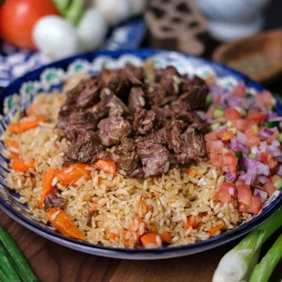 Beef rice Pilaf - Tender chunks of meat, fluffy rice, carrots, onions and cumin cooked in a seasoned broth.