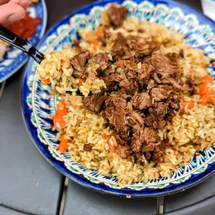Beef rice Pilaf-Tender chunks of meat, fluffy rice, carrots, onions and cumin cooked in a seasoned broth. Served with salad.