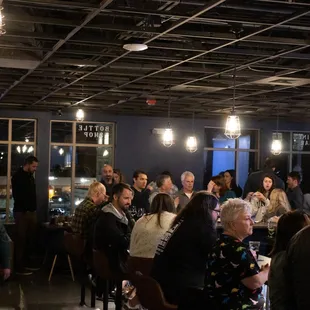 a large group of people sitting at a bar