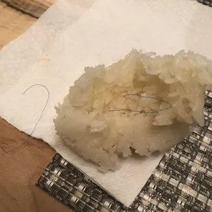 Tooth floss? 3 pieces in the rice... yuck.