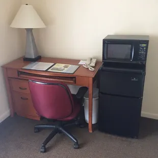 Desk with small refrigerator and microwave