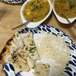 Garlic naan, rice, vegetarian daal mash and another veggie dish.
