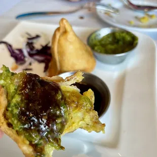 Subz Samosa with the sauce on it