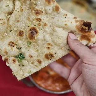 a hand holding a piece of bread