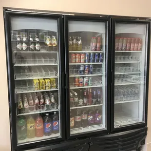 two refrigerators with drinks in them