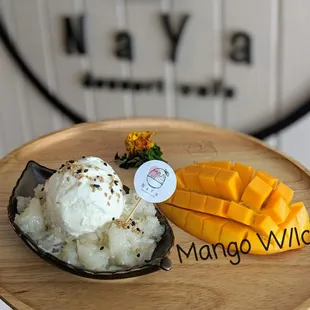 Mango W/Ice cream, sweet sticky, coconut Ice cream, half of fresh mango  for people (non-dairy) can take off the Ice cream