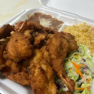 fried shrimp and rice in a styrofoam container