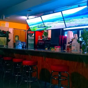 a bar with red stools