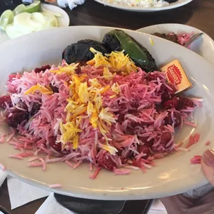 Albaloo polo - sour cherry rice with saffron rice, with a side of grilled tomato and grilled spicy pepper.