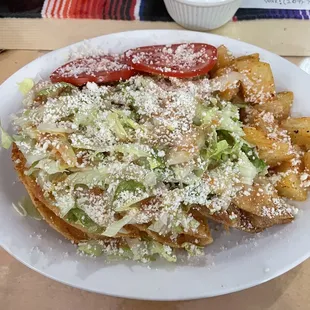 Tacos dorados de papa (fried soft tacos with potato, lettuce, cotija mexican cheese, tomato slices.  Jalapeno and tomato slices optional)