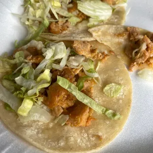 Uncooked tortilla, chicken, and lettuce