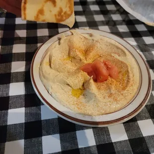 a bowl of hummus and pita chips