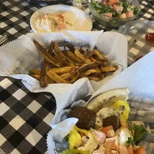 Half of falafel gyro, fries, Tabbouli Personal Salad, pita and hummus