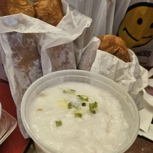 Classic Chinese breakfast: Rice congee with lean pork &amp; century eggs, with a fried cruller (salty in L , sweet on R).