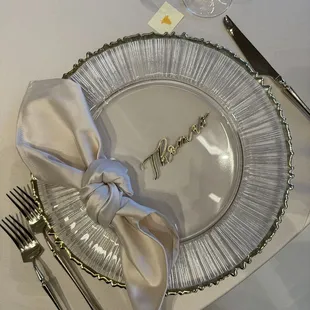 Charger, utensils, and napkin.