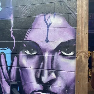 the face of a woman painted on the side of a building