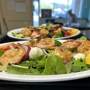Fresh salads topped with seafood