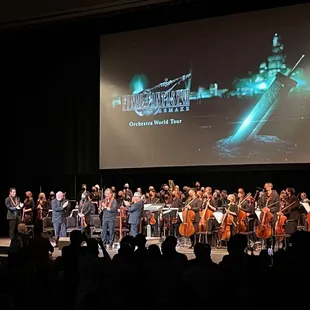 Second photo of orchestra with creator and also composer