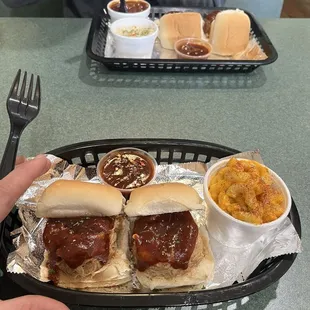 a tray of hot dogs and a side of macaroni and cheese