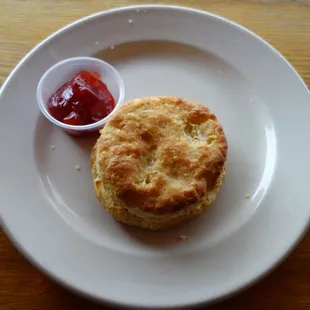 a biscuit on a plate with ketchup