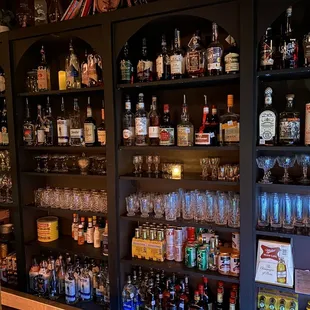 shelves of alcohol bottles and glasses