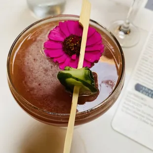 a drink with a flower on the stem