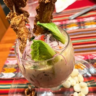 Leche de tiger (fried fish, shrimp,fresh fish,Peruvian spices,corn and onions