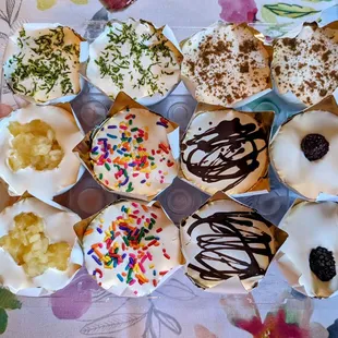 Clockwise from top left: Key Lime, Pumpkin, Blackberry, Chocolate, Sprinkles, and Pineapple Mini Cheesecakes