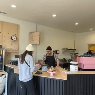 two people standing at a counter