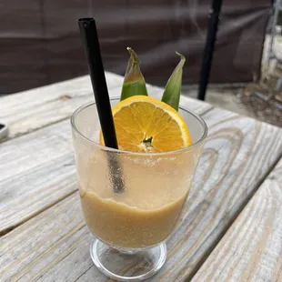 an orange slice in a glass of coffee