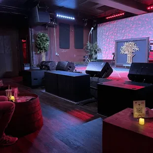 a room with a stage and couches