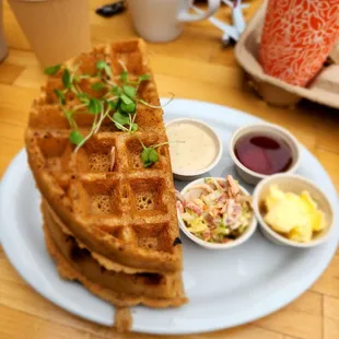 a plate of waffles and a cup of coffee