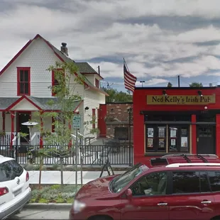 two cars parked in front of the building