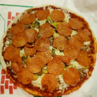 Take and bake pizza with sausage, pepperoni, mushrooms, onions with my green peppers that I asked for missing.